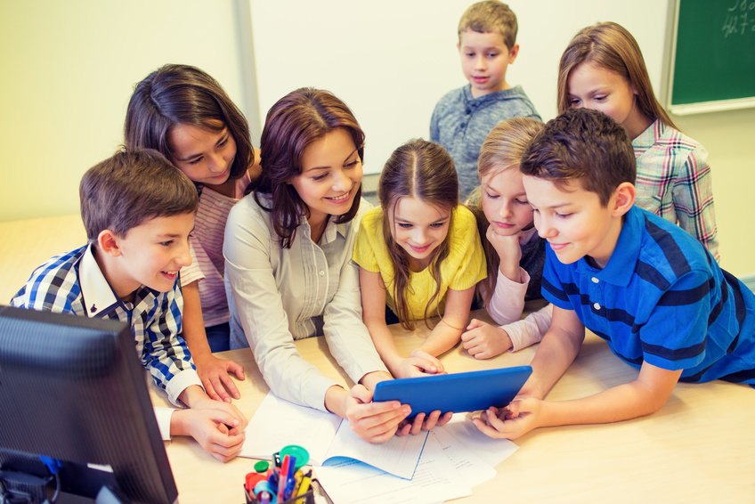 group of kids with teacher and tablet pc at school